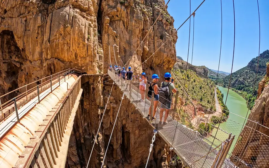 A guide leading a group along the Caminito del Rey walkway