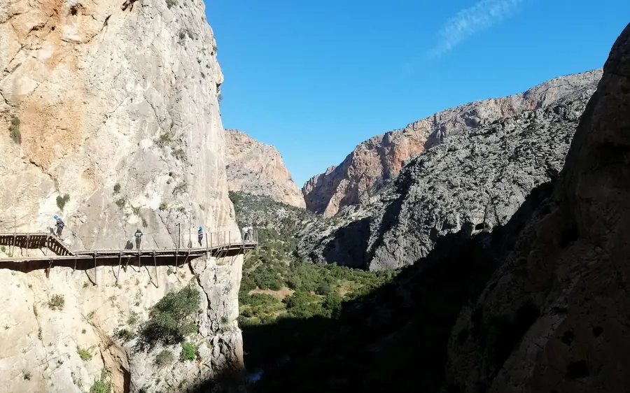 A small group of walkers on the Caminito del Rey with a guide