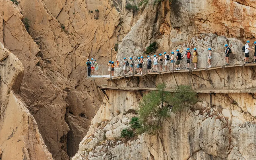 Walkers on the Caminito del Rey boardwalk high above the Guadalhorce river
